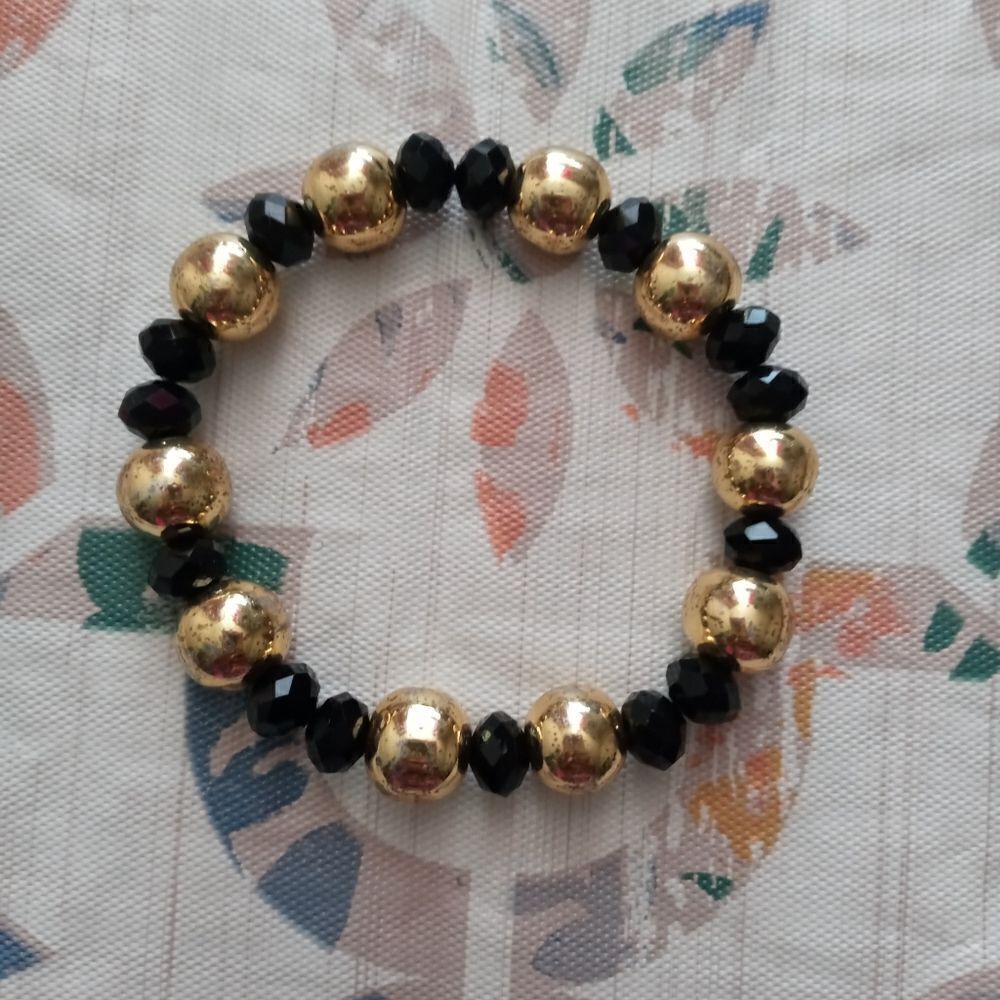 One used gold&blk bracelet without charm